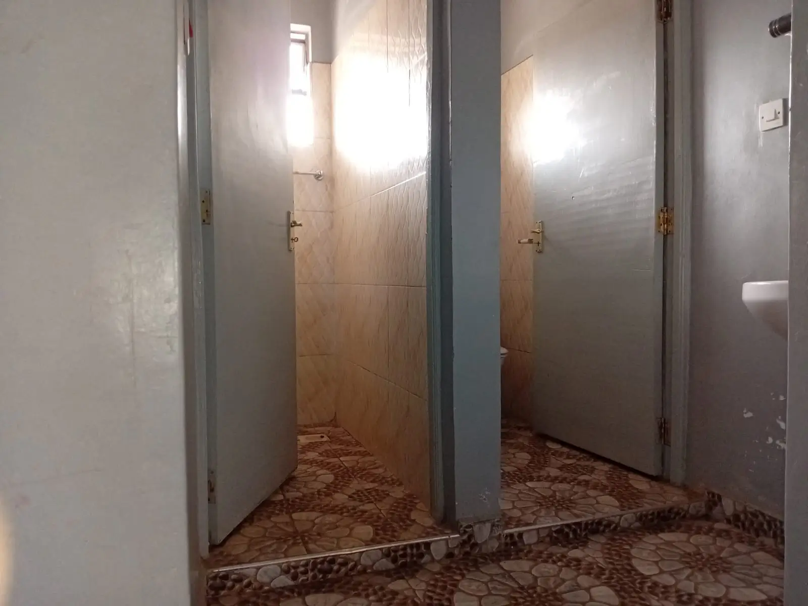 Building corridor with multiple doors and neutral finishes