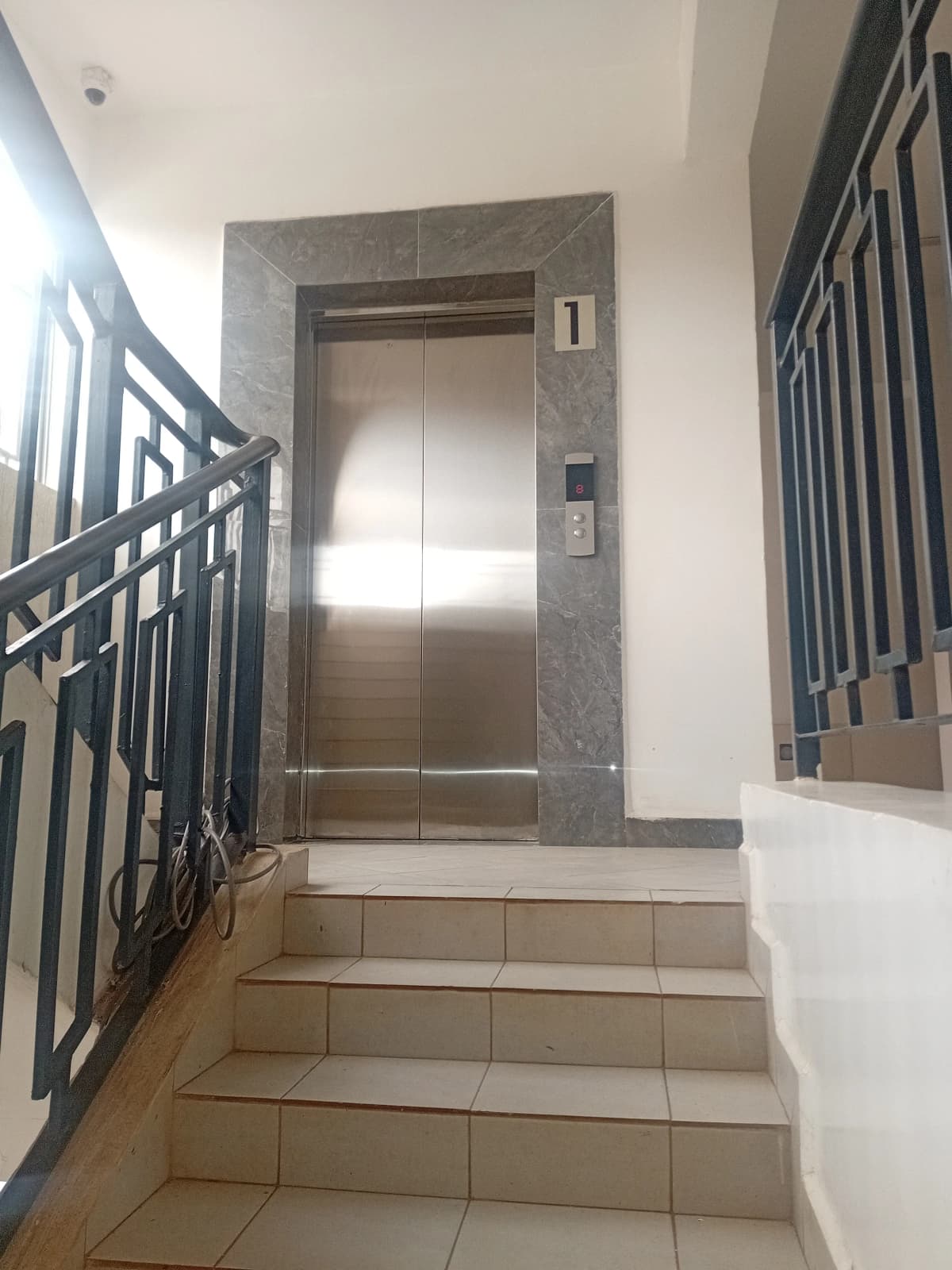 Building lobby with elevator and staircase access