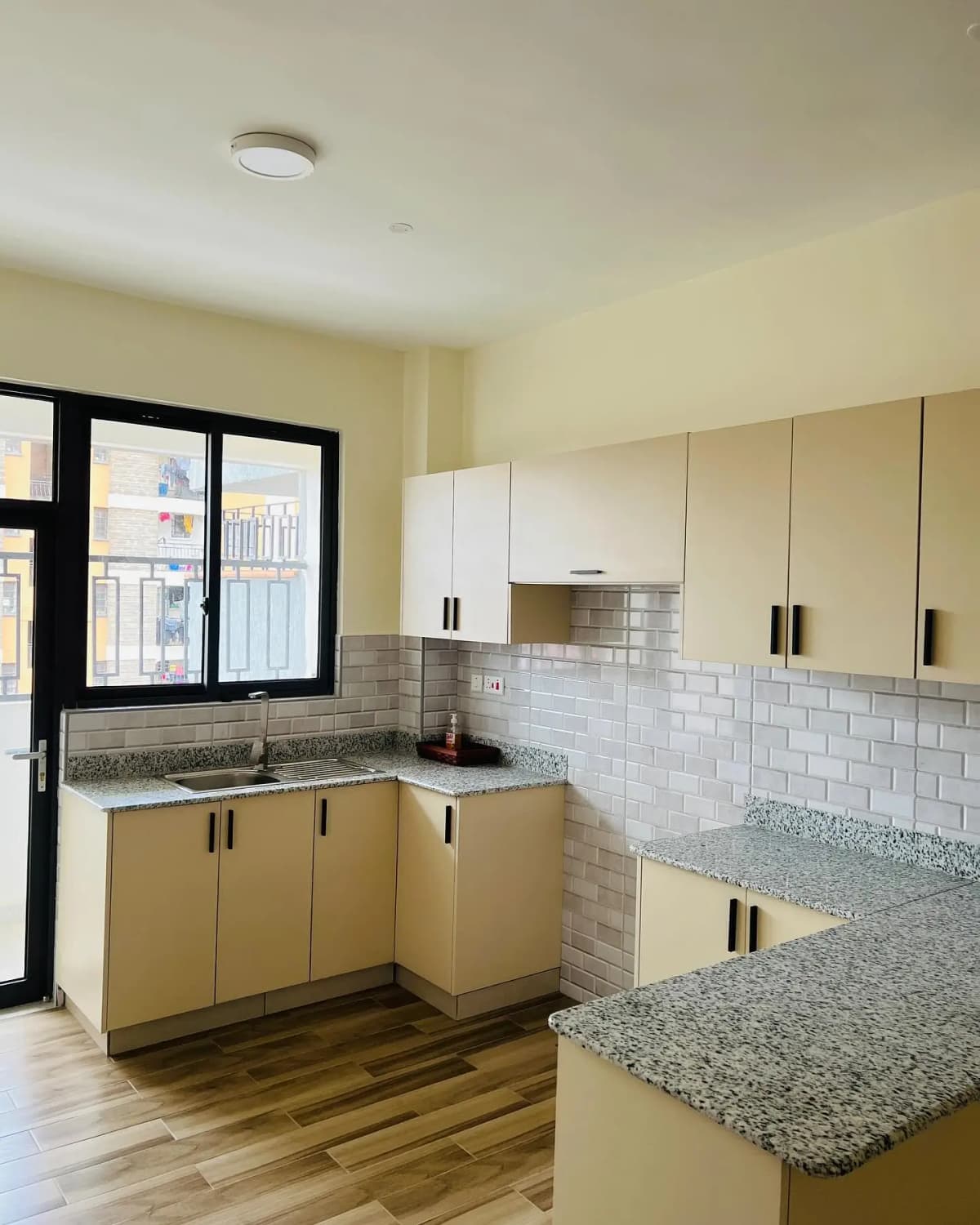 Modern kitchen with cream cabinetry and granite countertops