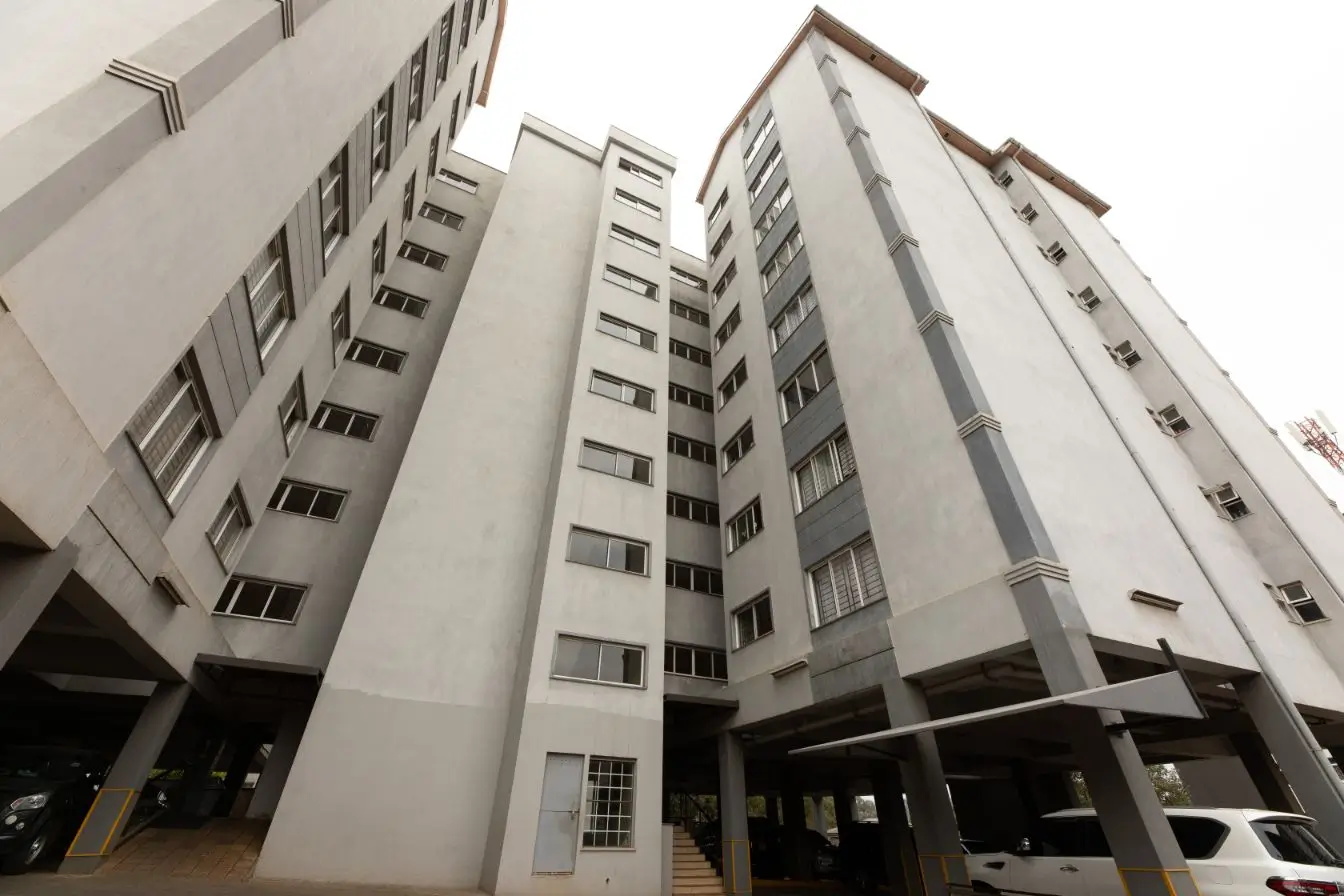 Multi-story residential building facade with ground-level parking