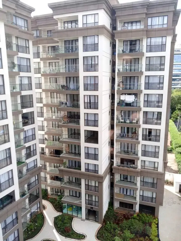 Modern multi-story residential building with balconies and landscaping