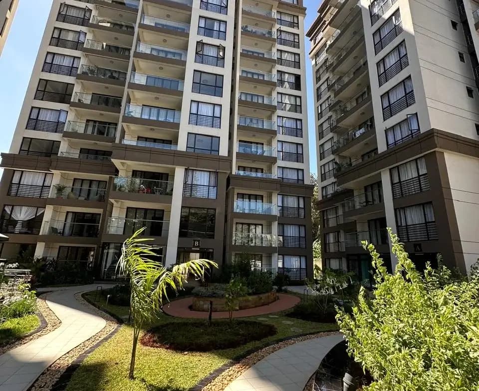 Multi-story residential building with manicured courtyard landscaping