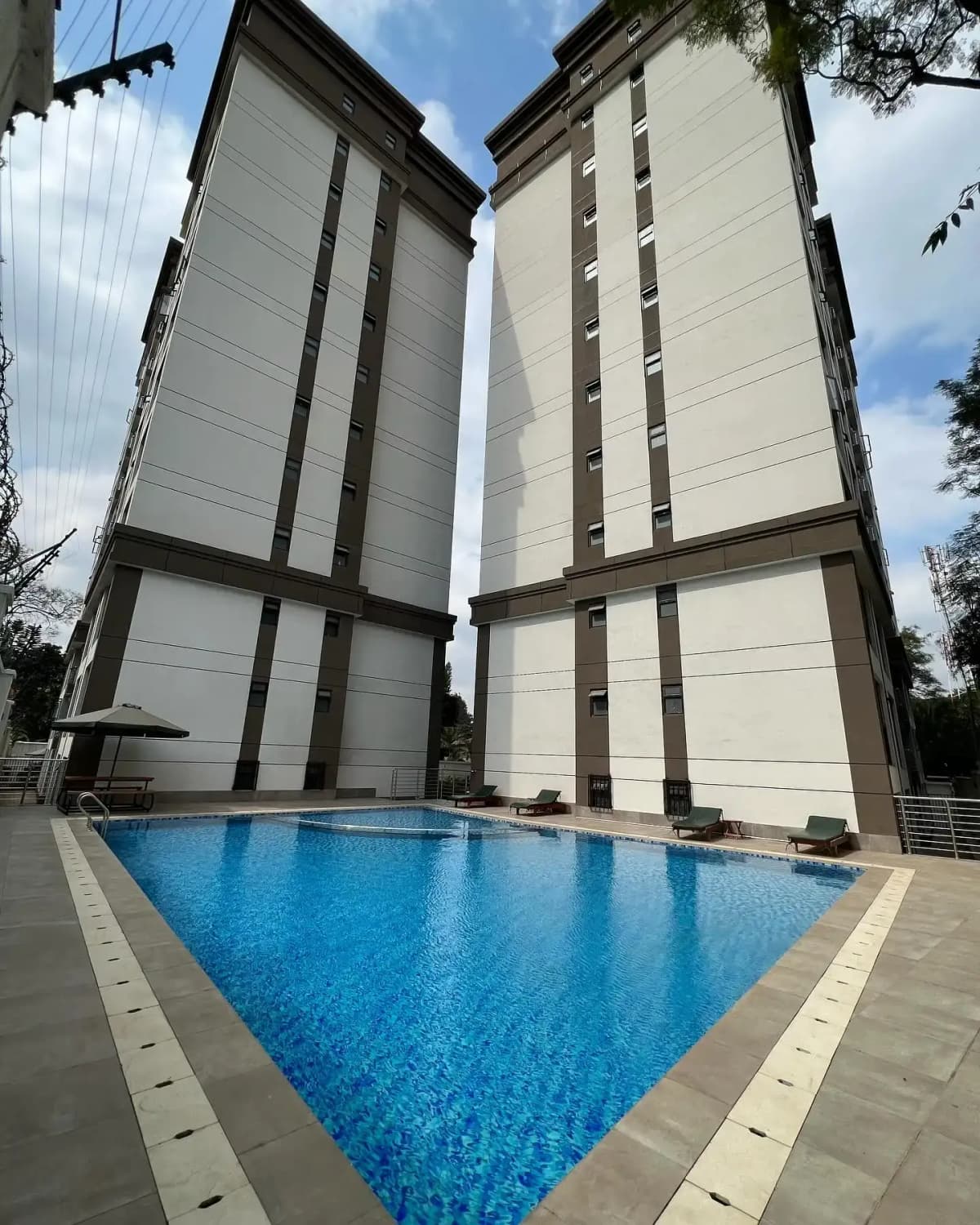 Resort-style swimming pool with modern residential towers