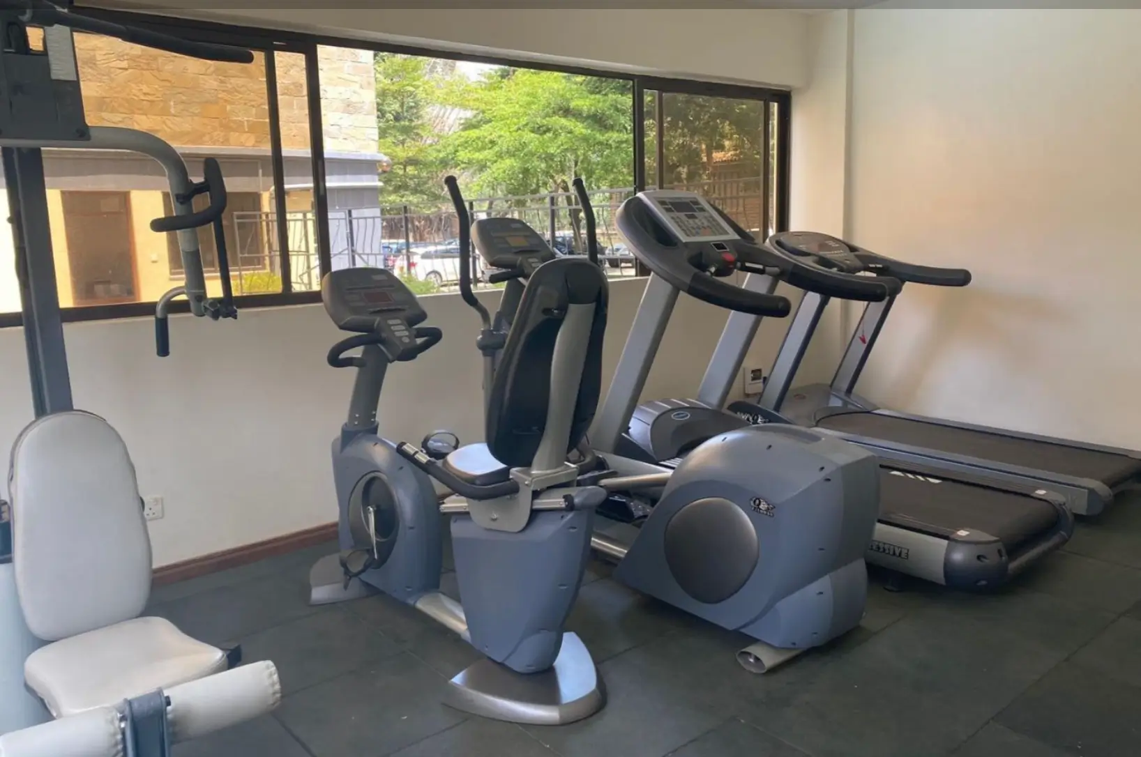 Modern gym with stationary bikes, treadmill, and exercise equipment