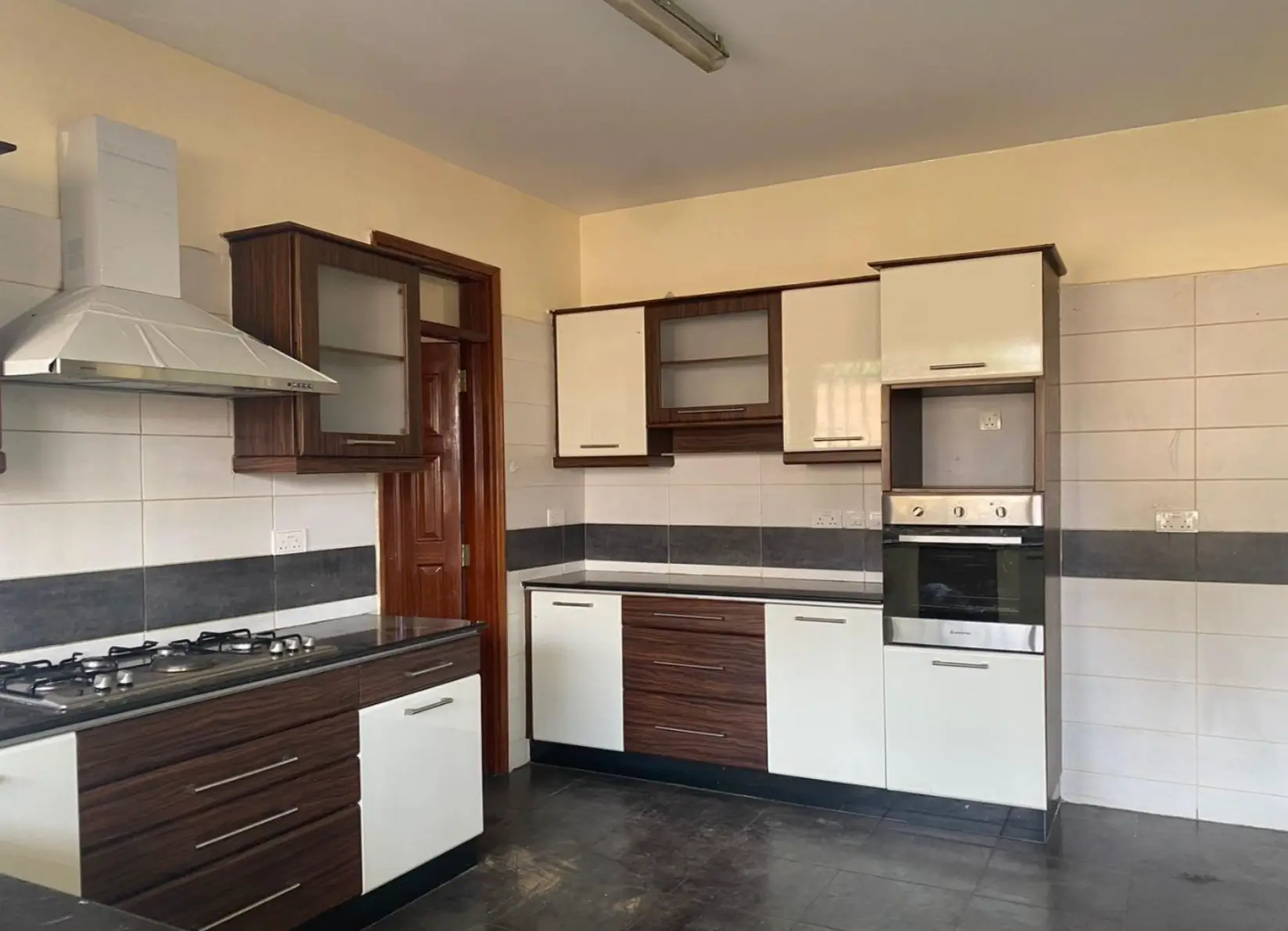 Modern kitchen with dark wood cabinetry and stainless steel appliances