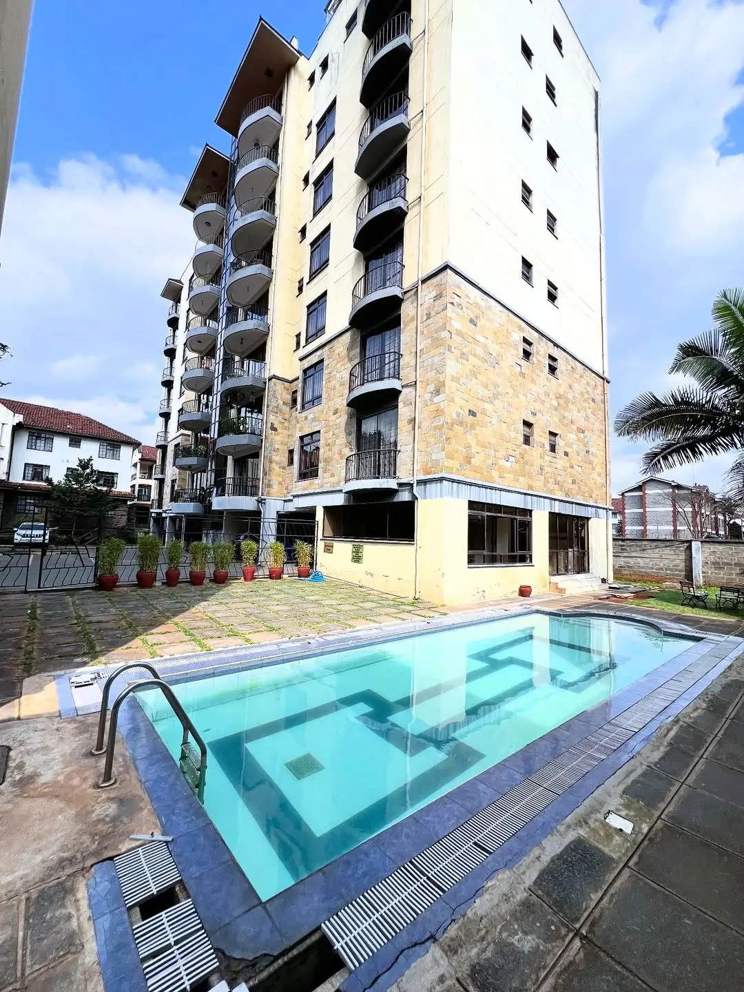 Modern residential pool with apartment building backdrop