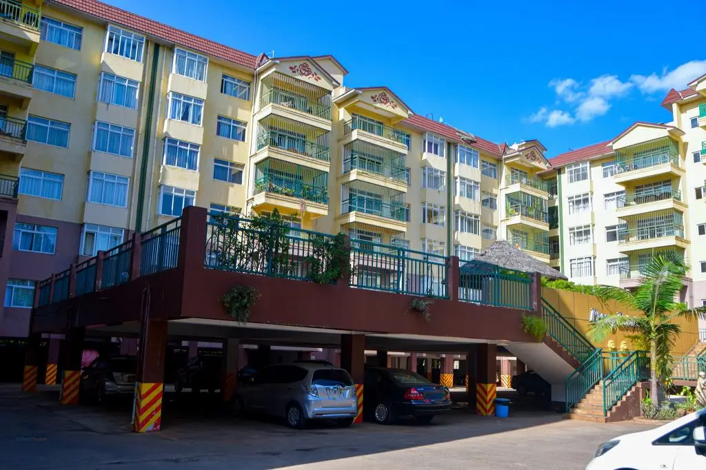 Underground parking garage with residential building facade above