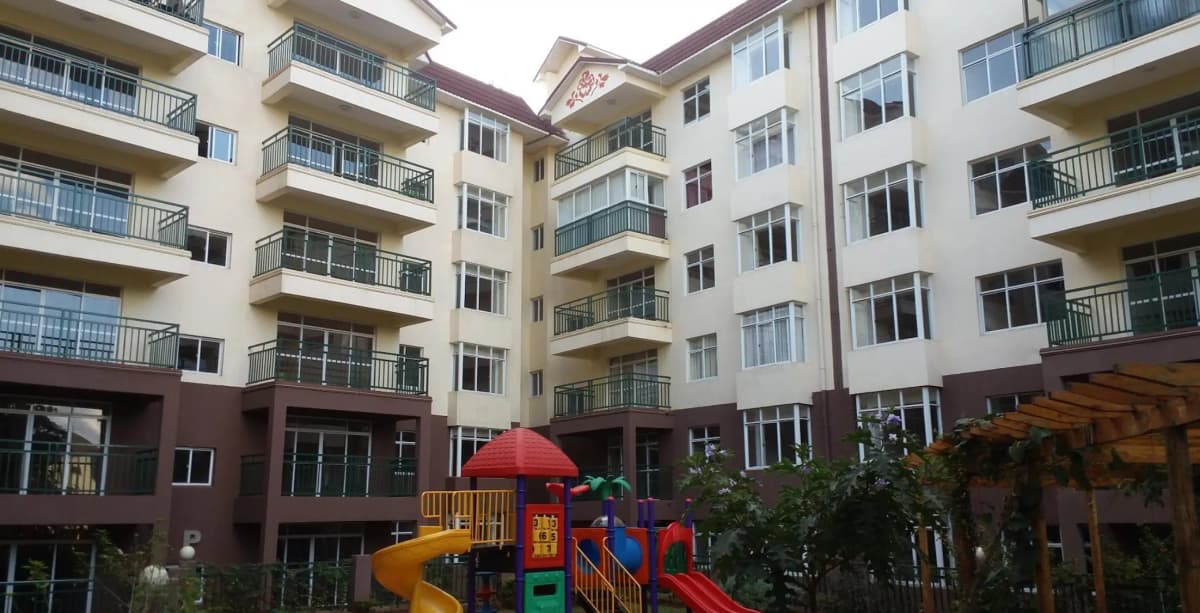 Multi-story residential building with children's play area compound