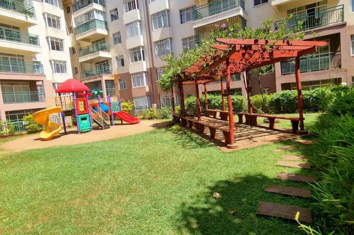 Landscaped compound lawn with playground and pergola structures