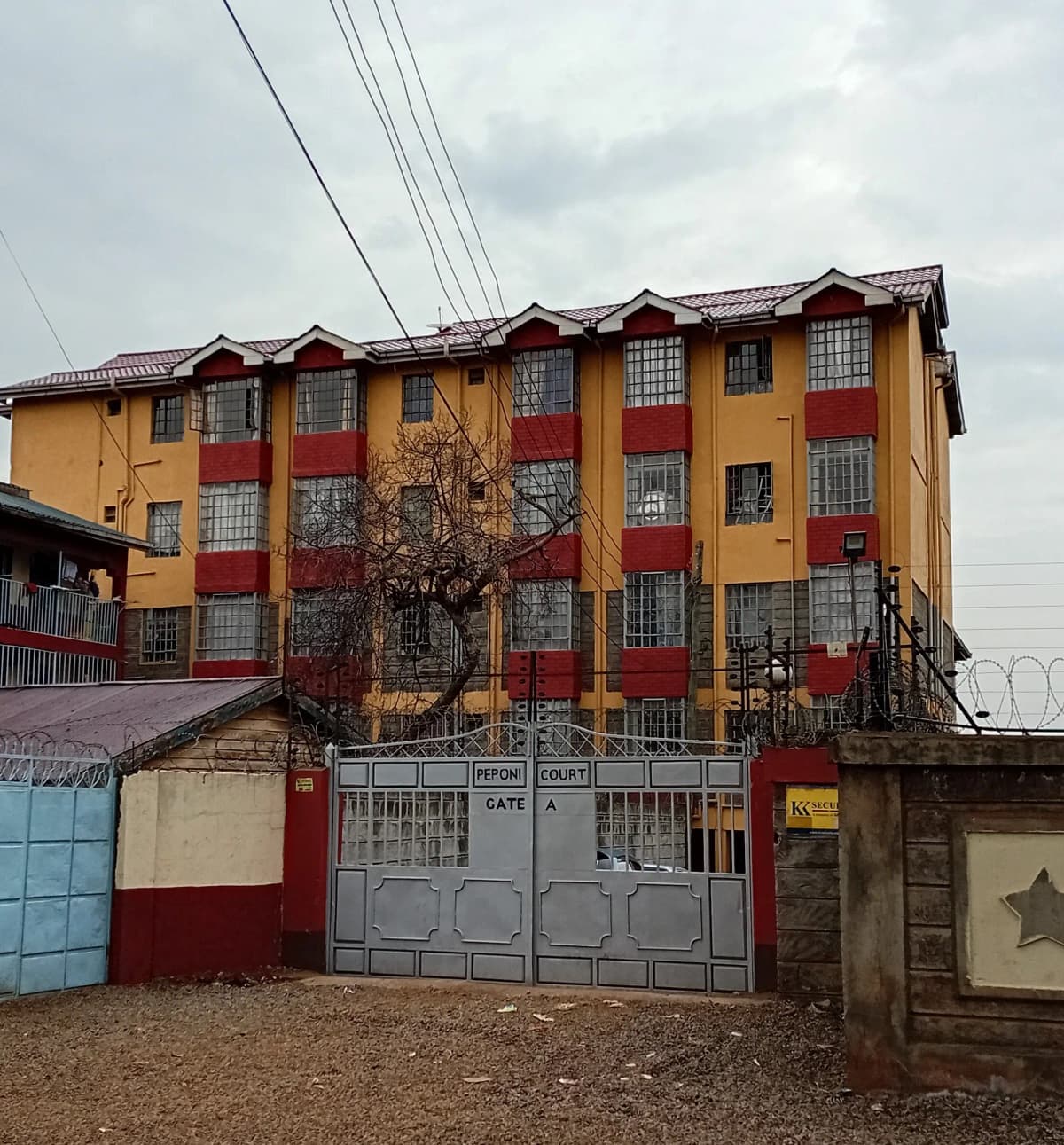 Multi-story residential building with yellow and red facade