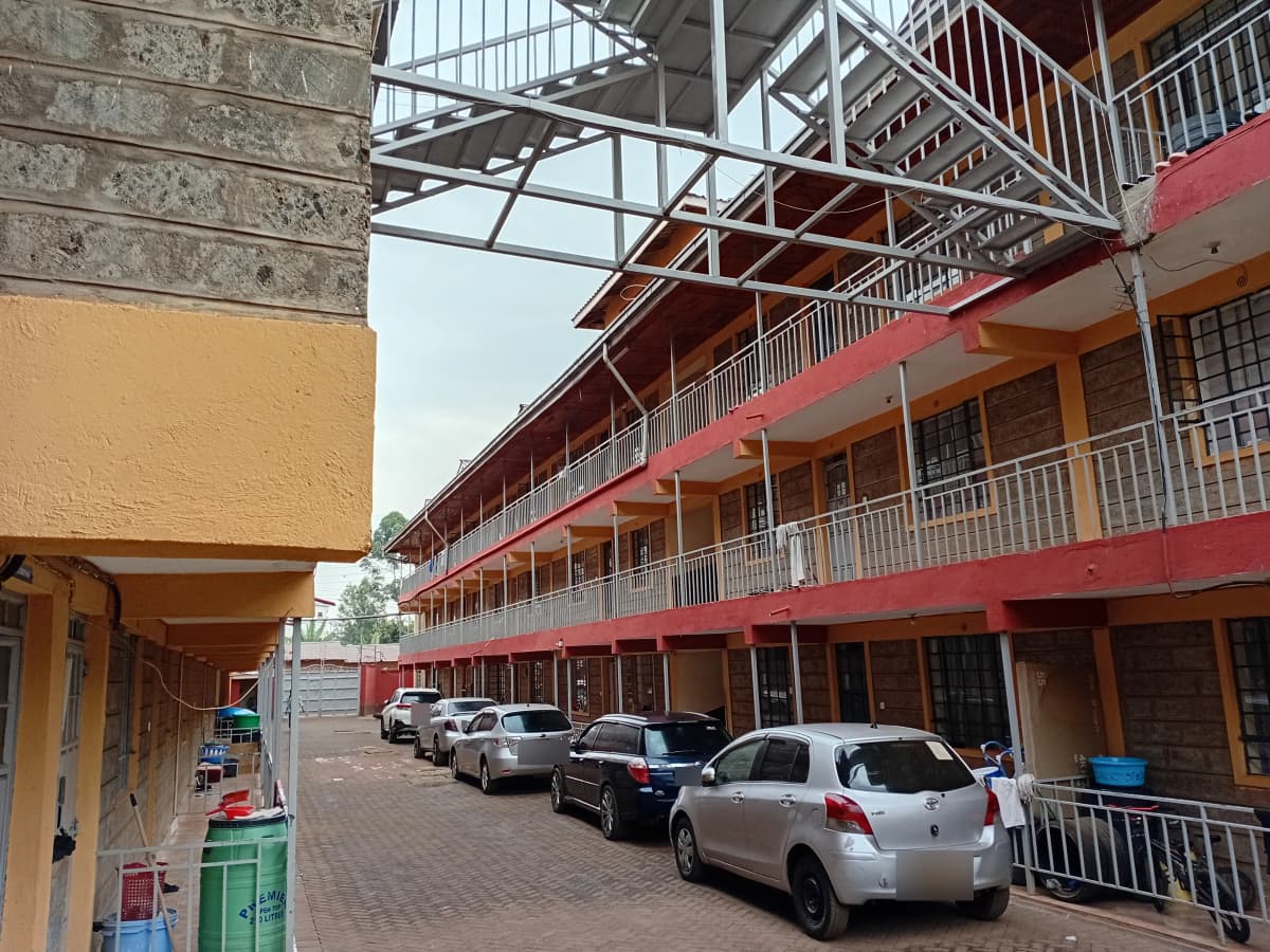 Multi-level apartment complex with covered parking bays