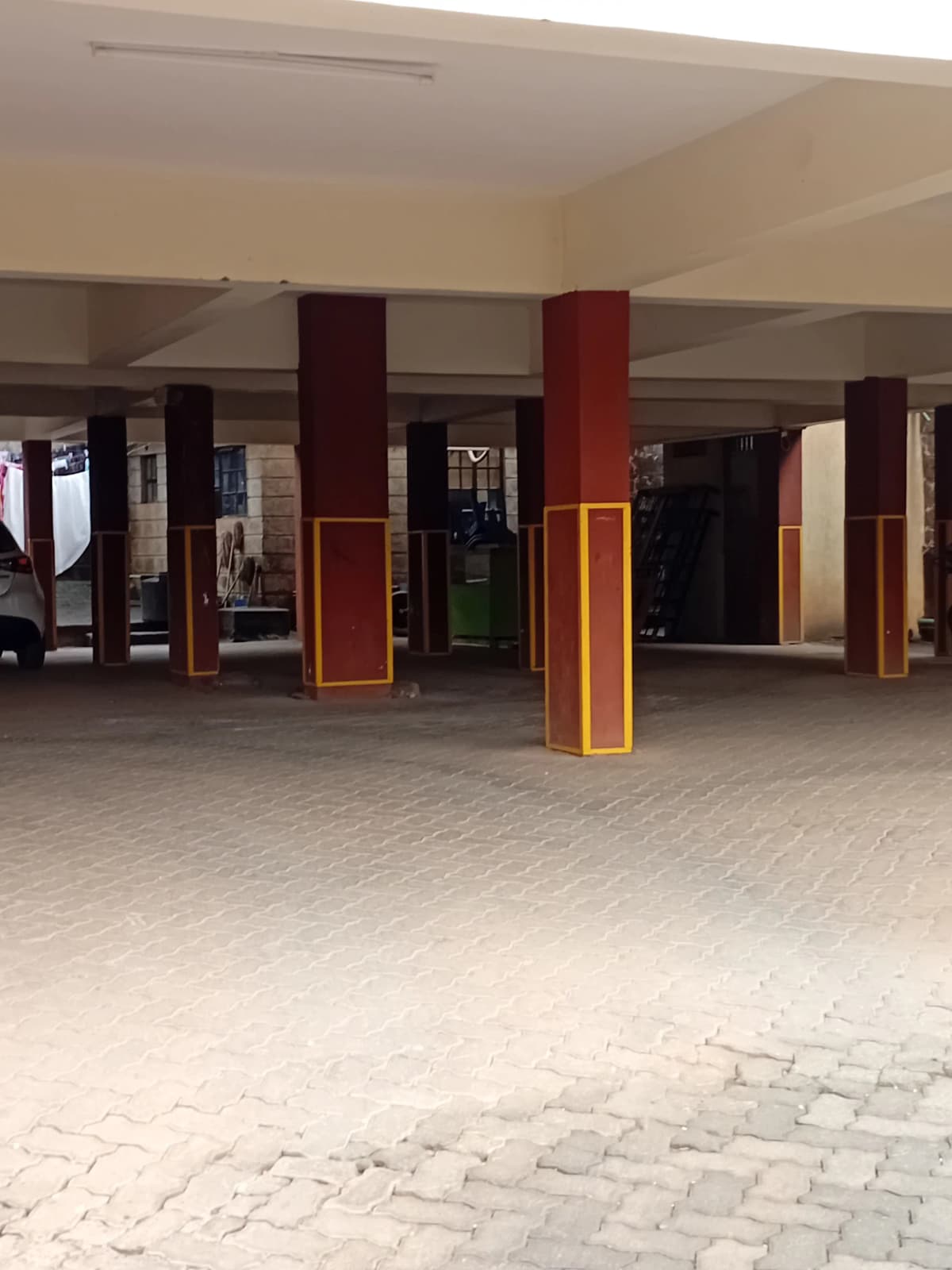 Spacious covered lobby with columns and paved flooring