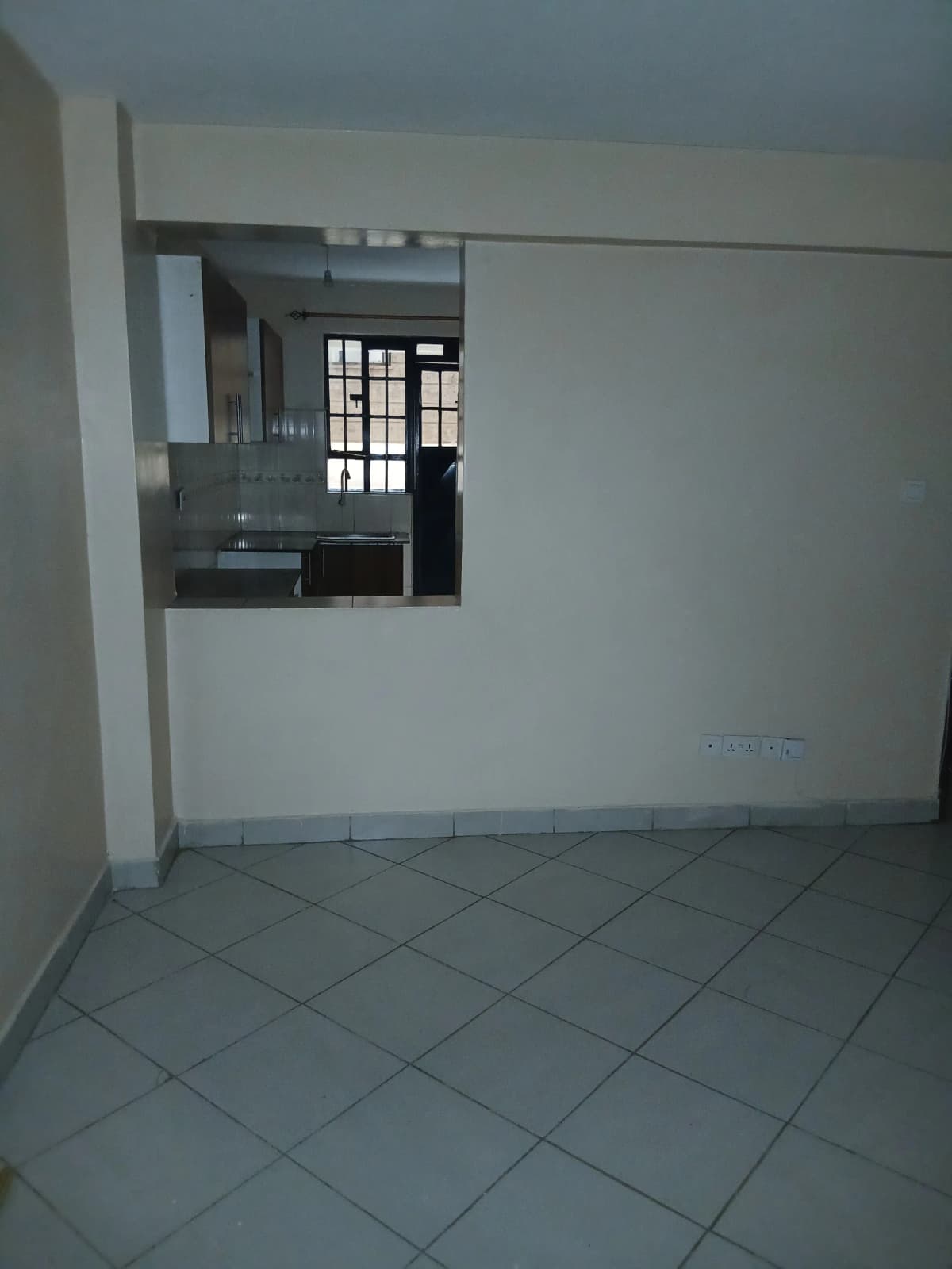 Open-plan living space with kitchen pass-through visible