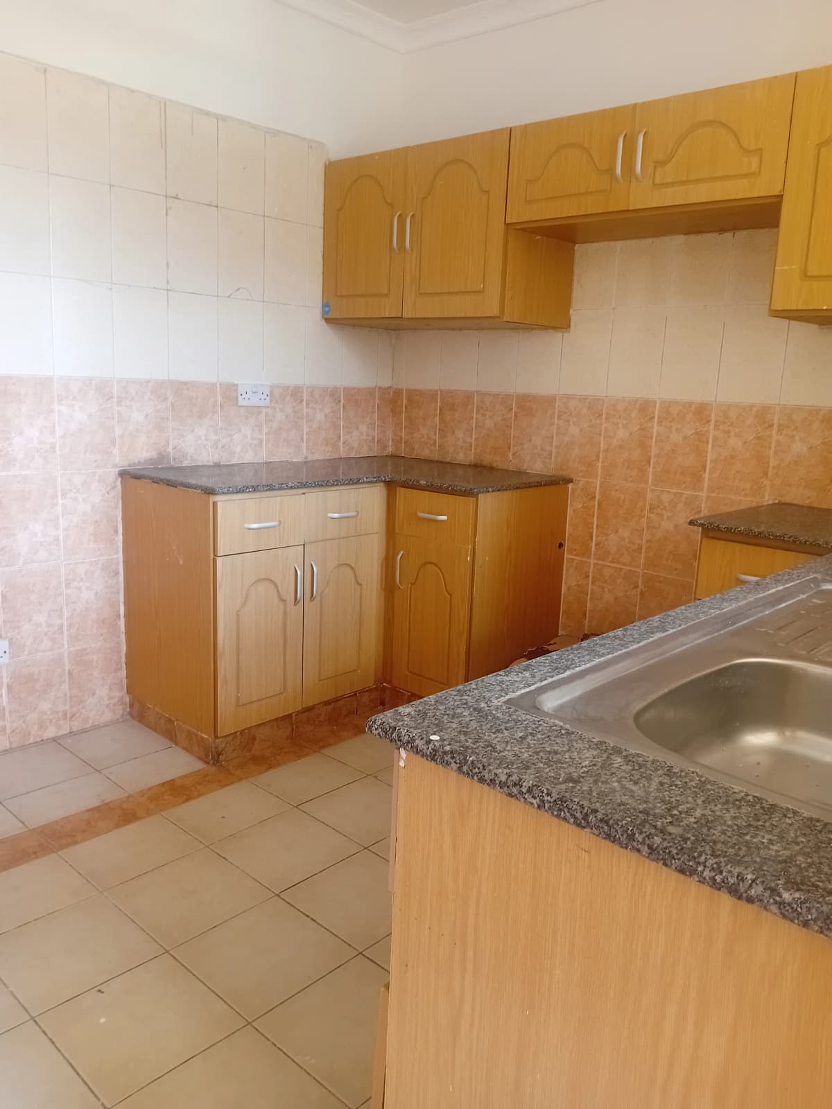 Spacious kitchen with wooden cabinets and granite countertops