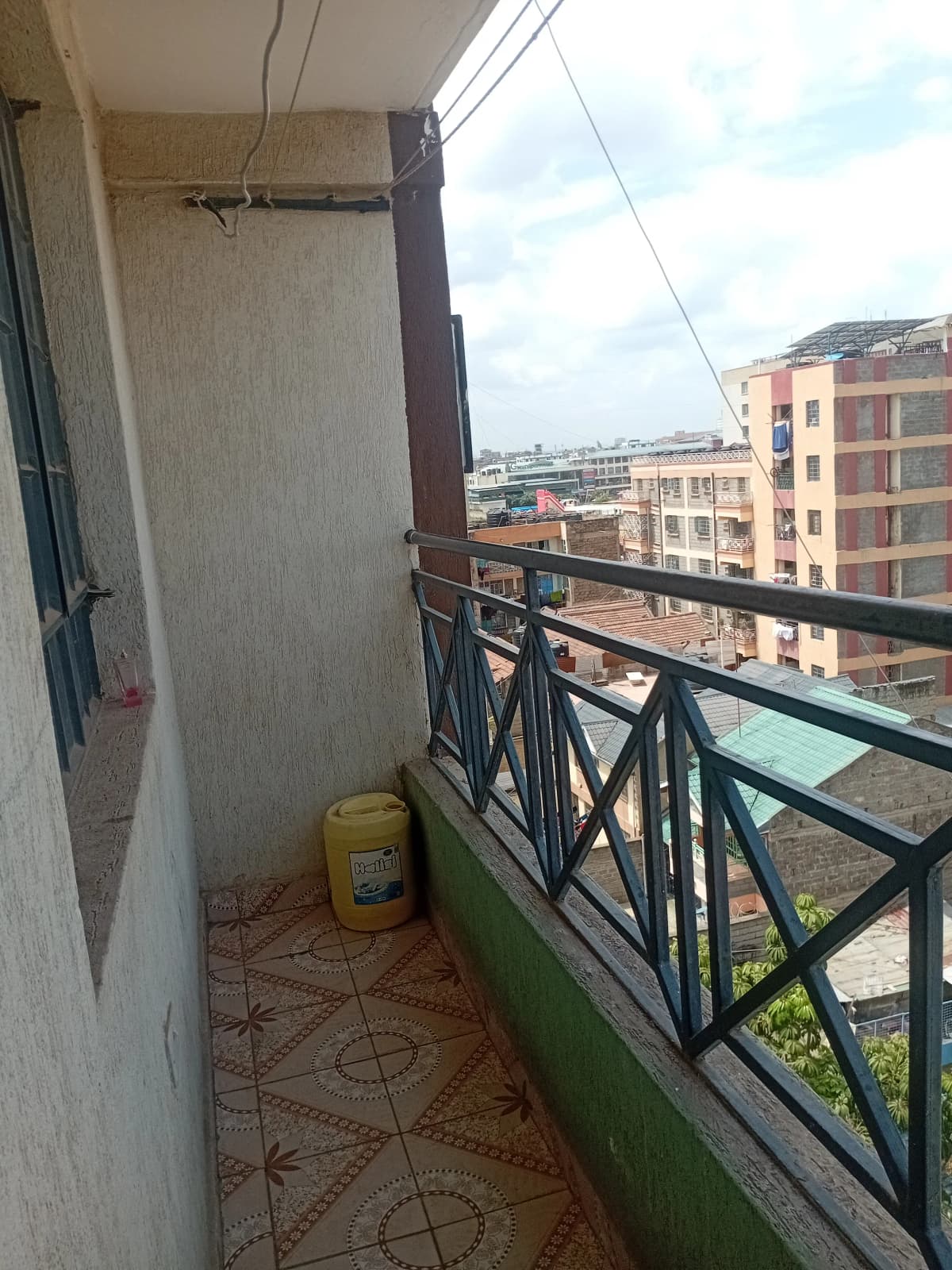 Elevated balcony with city skyline and residential buildings view