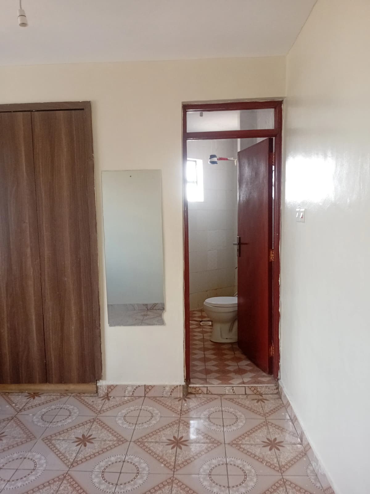 Hallway with open bathroom door revealing toilet and sink
