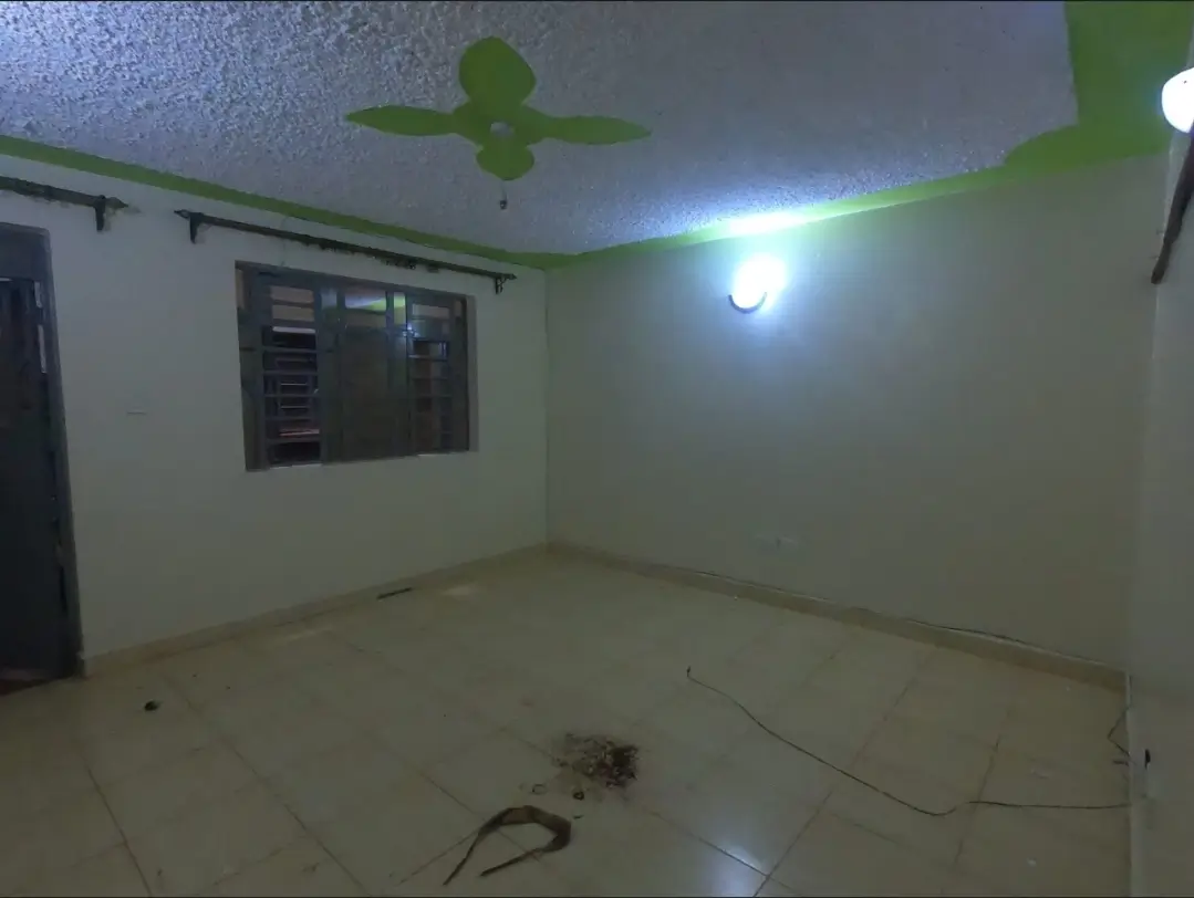 Empty bedroom with ceiling fan, minimal furnishings