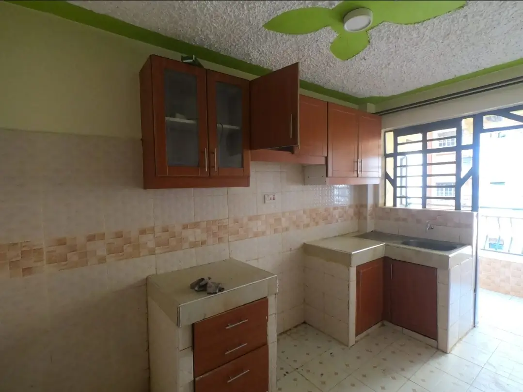 Compact kitchen with wooden cabinets and tiled backsplash