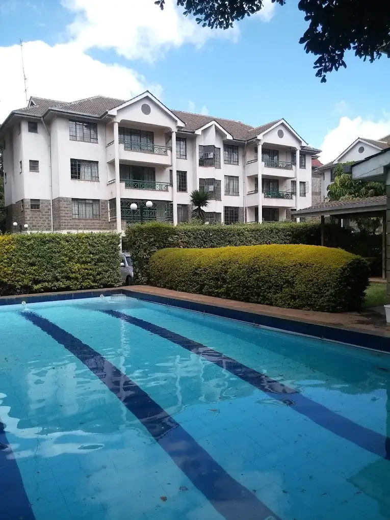Olympic-style lap pool with residential building backdrop