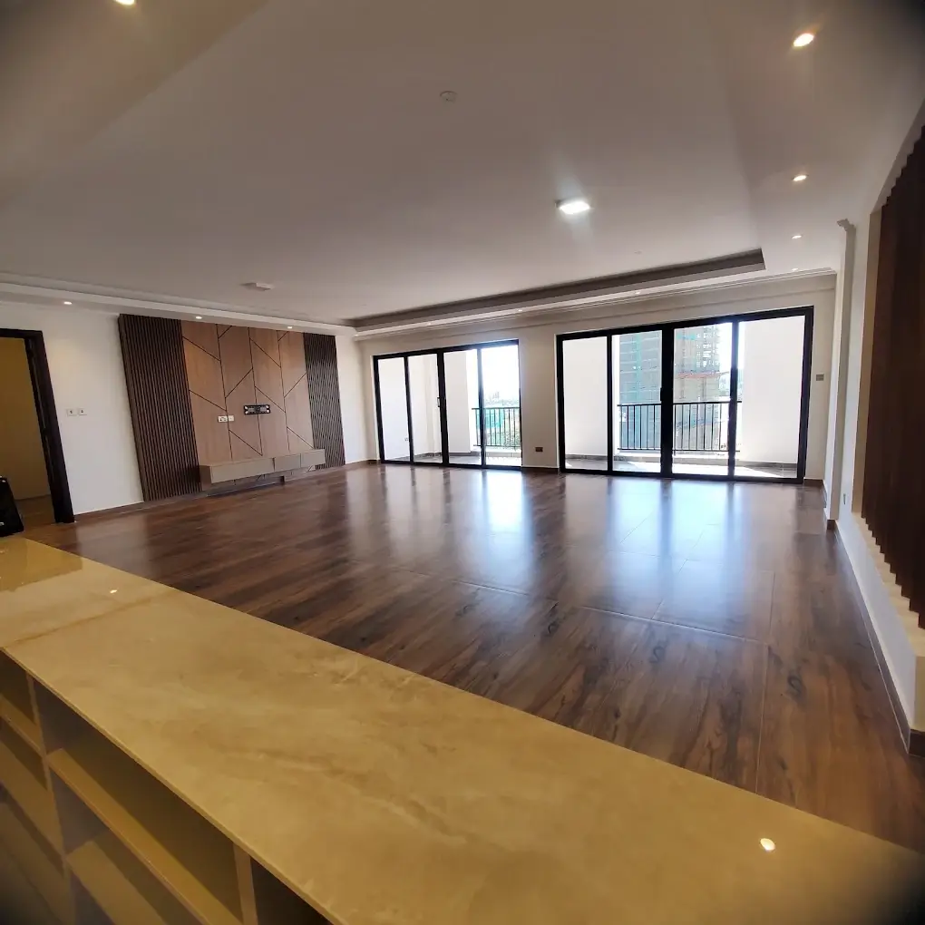 Spacious open-plan living area with dark wood flooring
