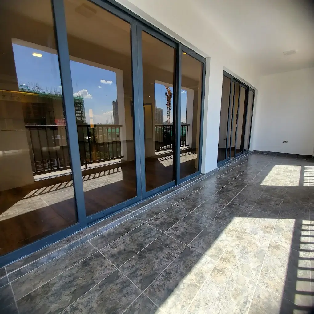Modern balcony with city skyline views through large glass doors