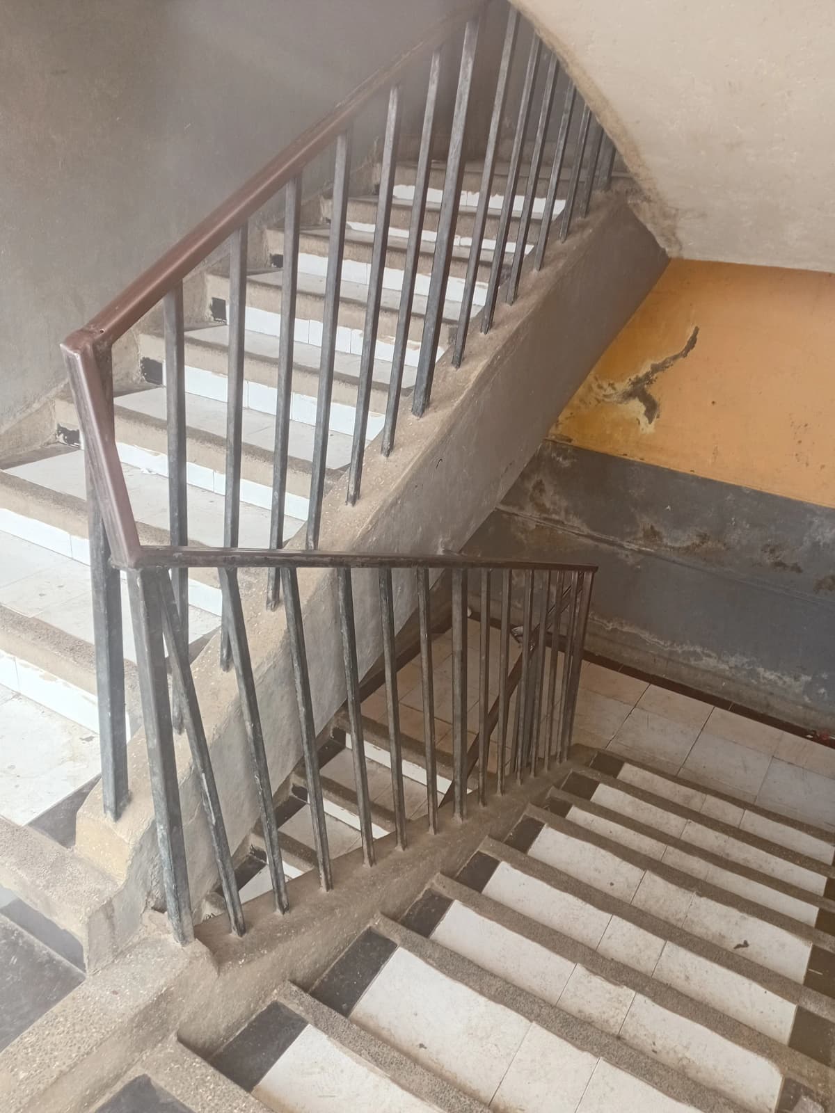 Internal stairwell with metal railings, concrete steps