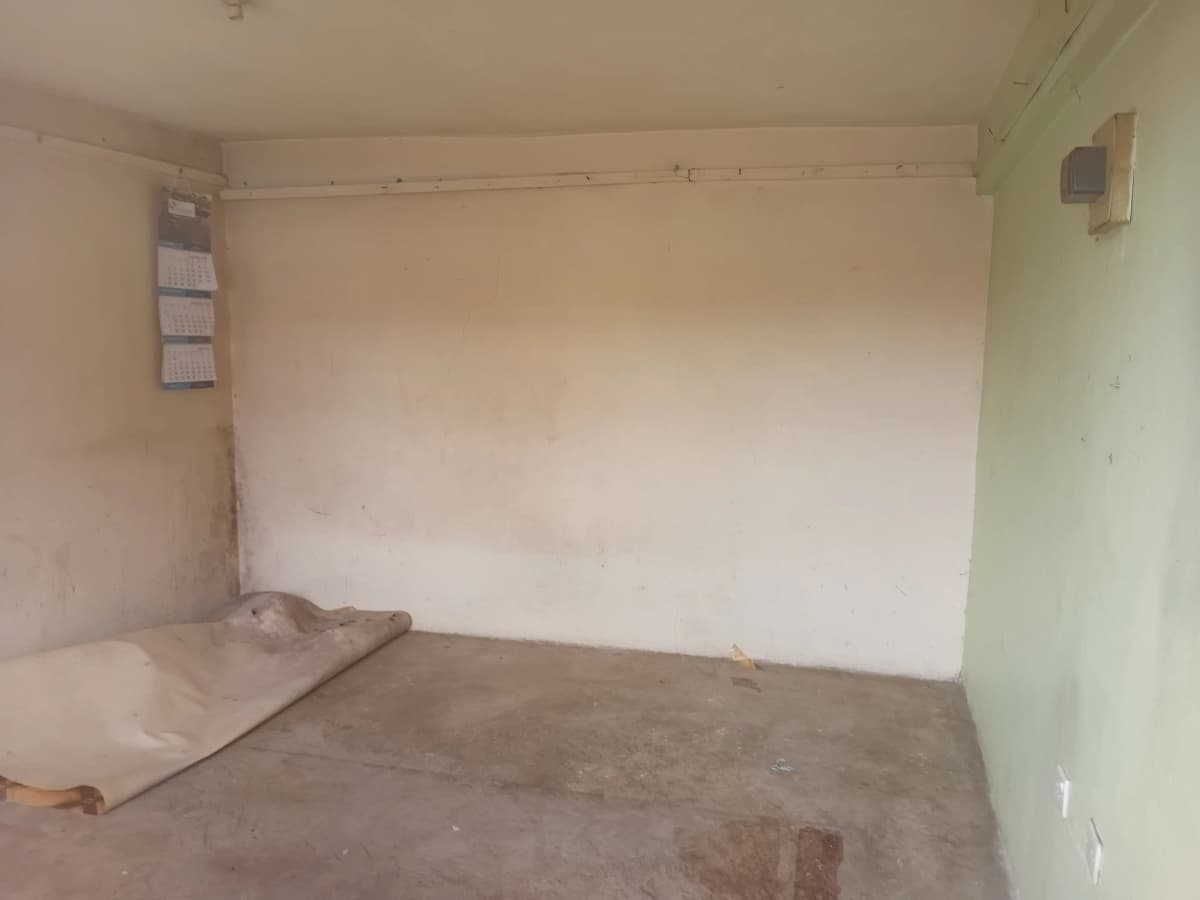 Empty room under renovation with bare walls and floor