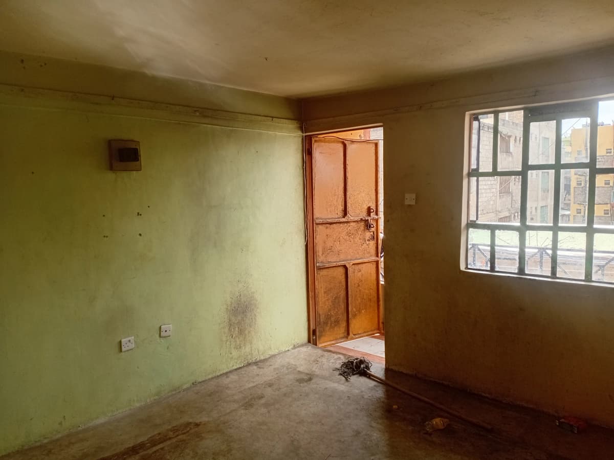Empty bedroom with wooden door and large window