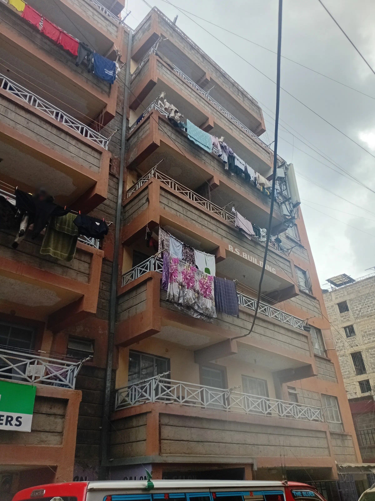 Multi-story residential building facade with balconies and laundry