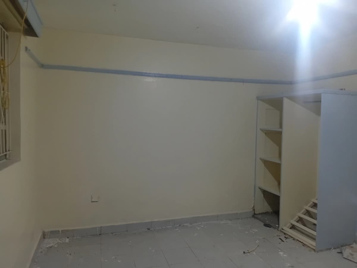 Unfurnished bedroom with built-in shelving unit