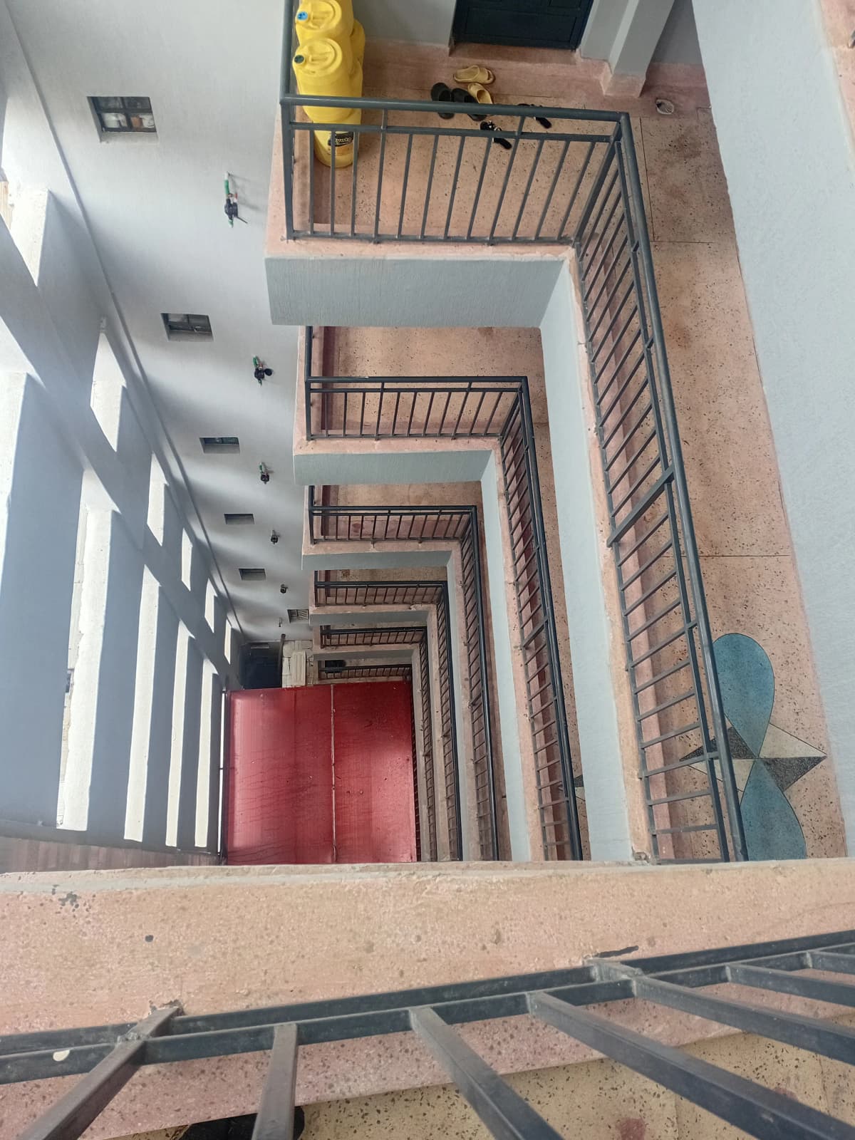 Multi-story stairwell with metal railings and natural light