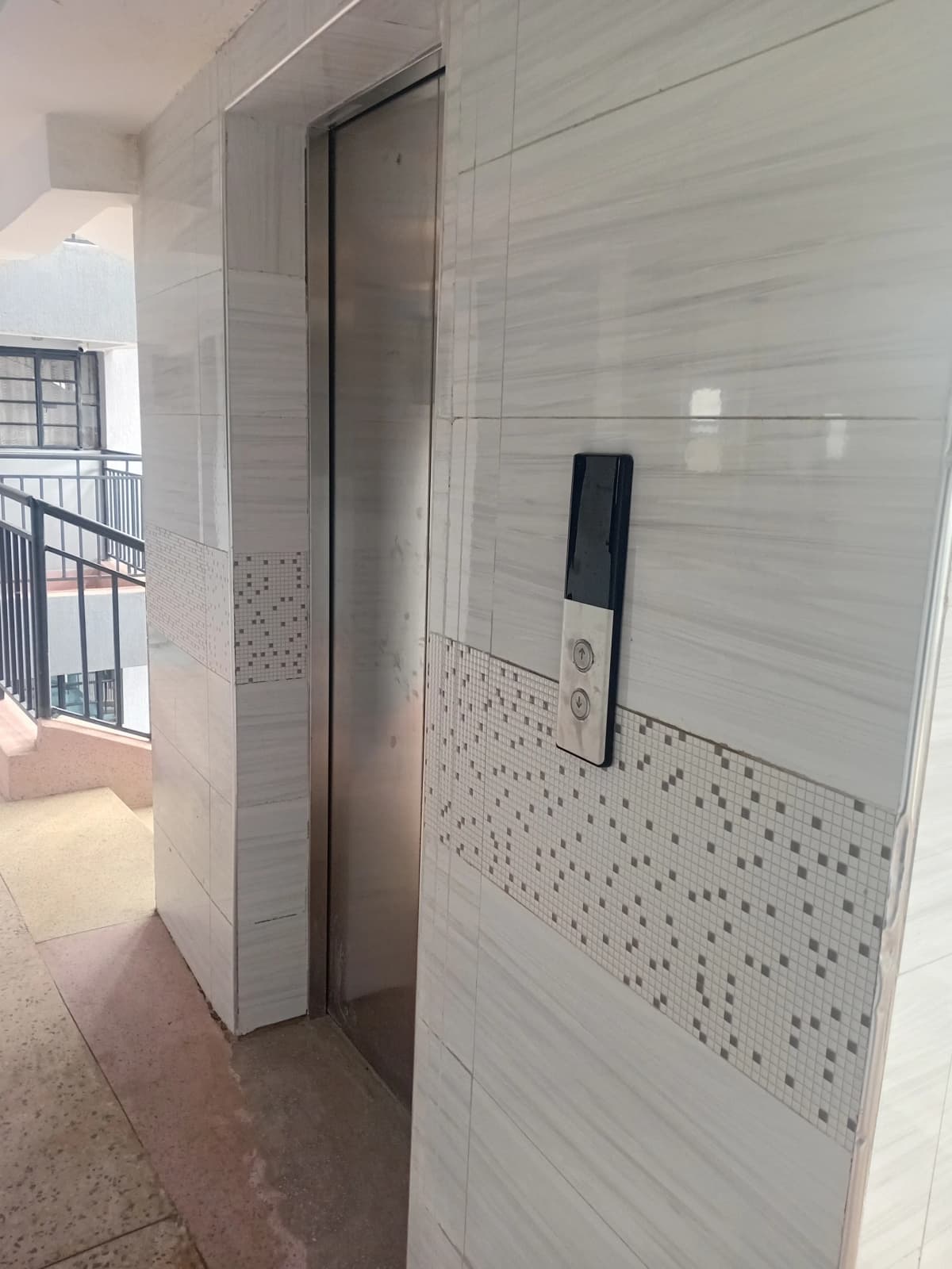 Modern bathroom with tiled walls and glass shower enclosure