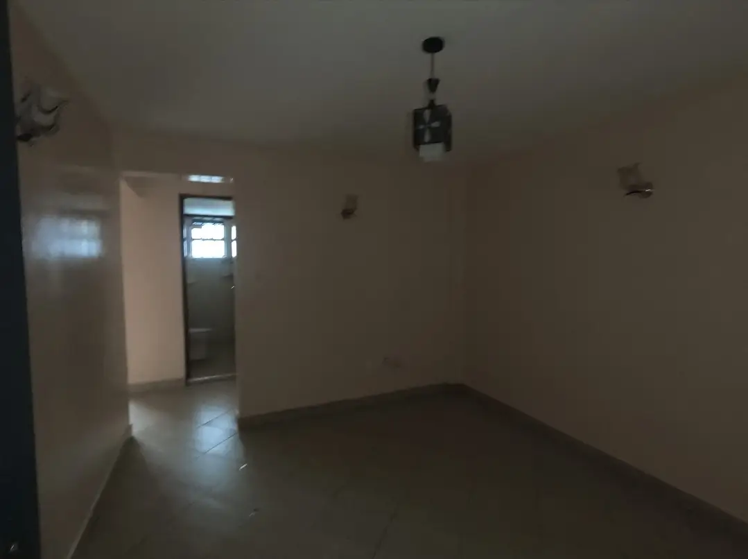 Empty living room with polished concrete floor and pendant light