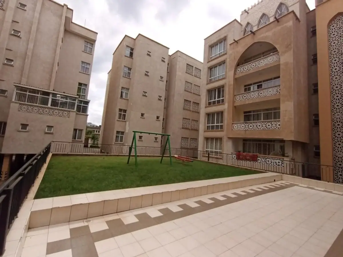 Compound grounds with manicured lawn and residential buildings