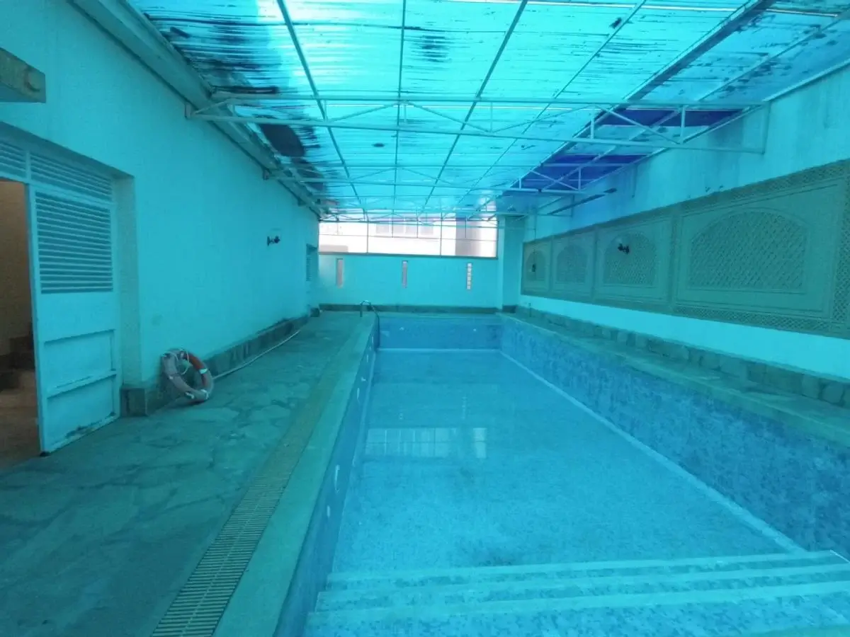 Indoor swimming pool with lane markings and skylights