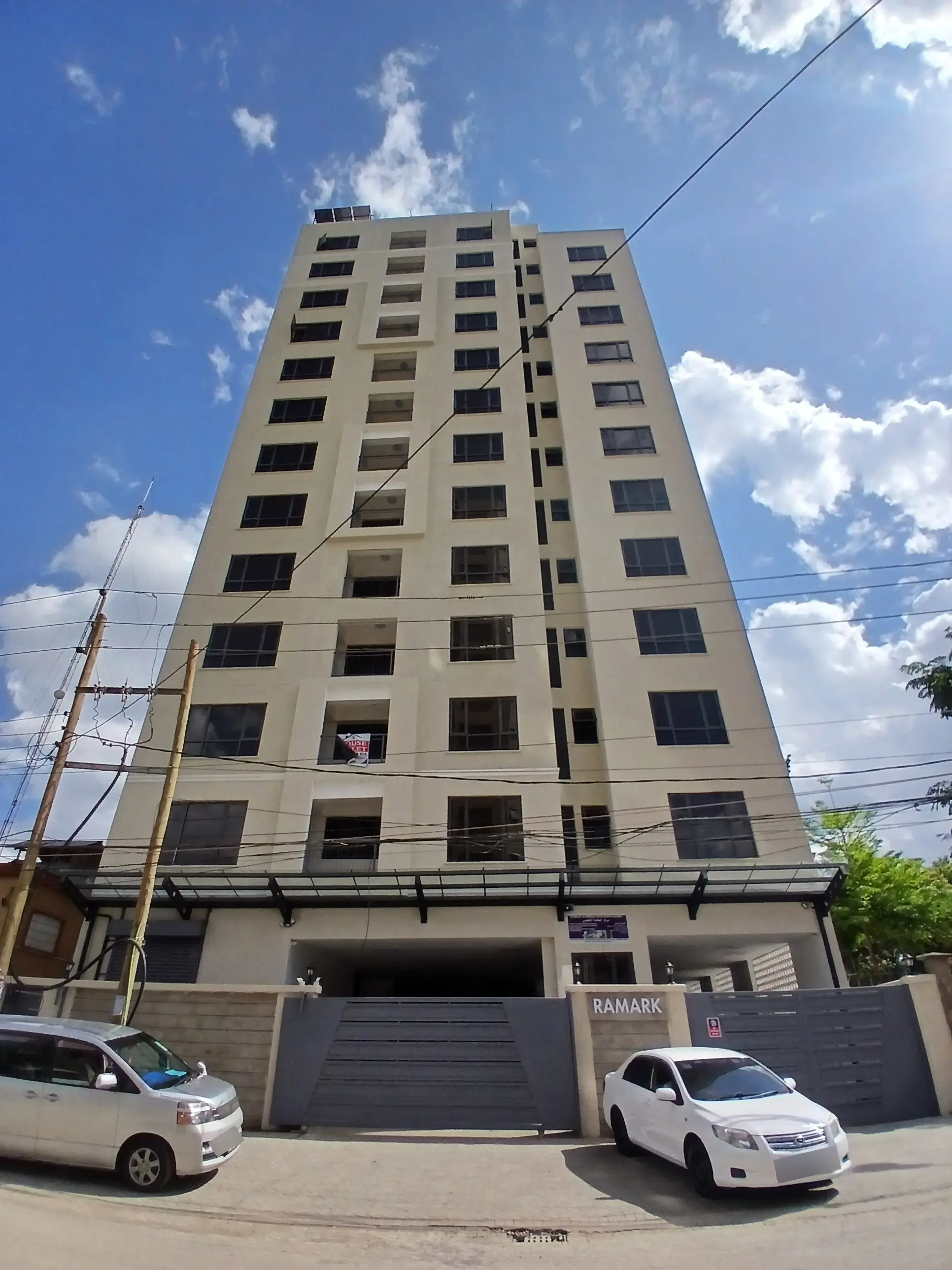 Multi-story residential building facade with ground-level parking