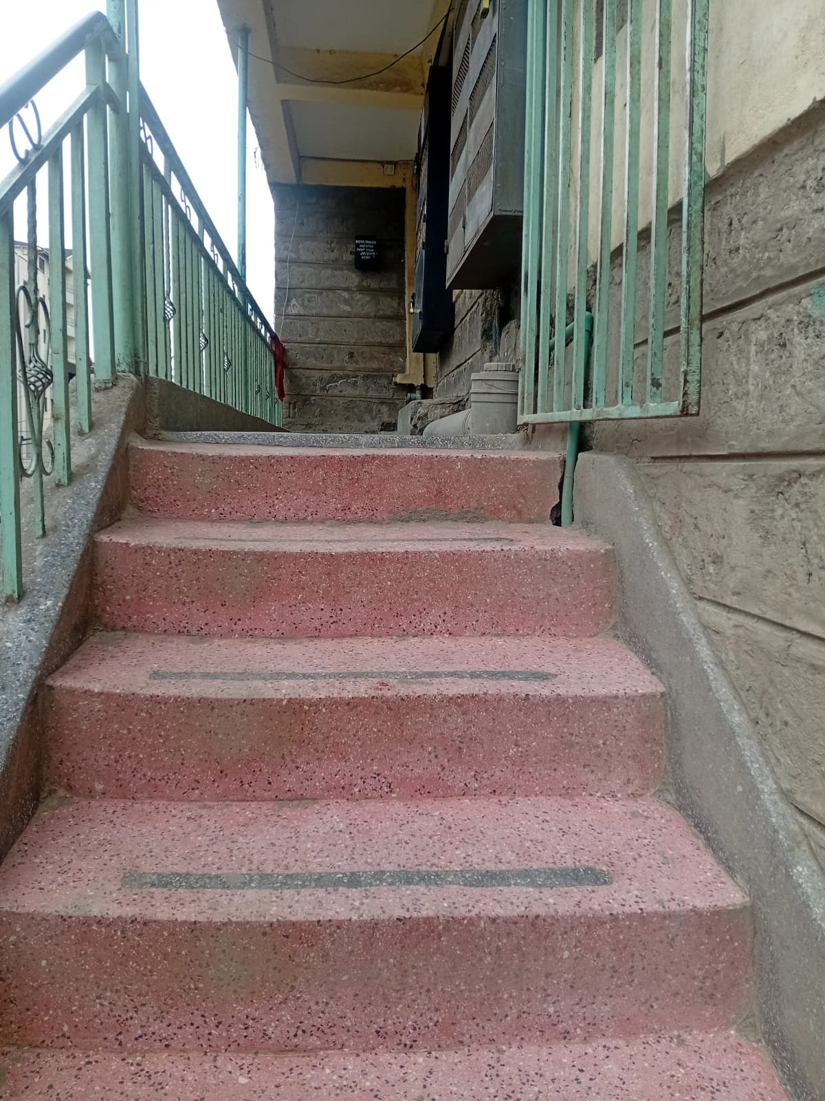 Common stairway with metal railings and concrete walls