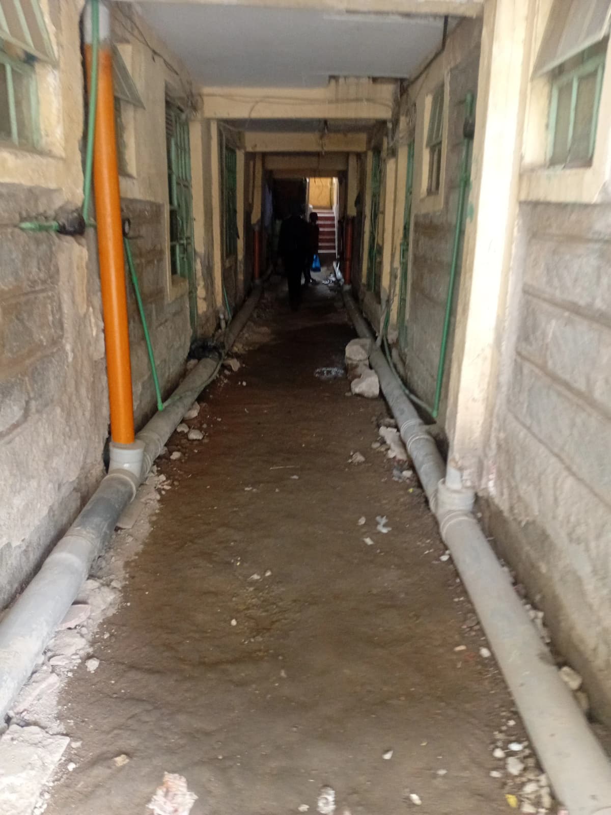 Long corridor with concrete flooring, under construction or renovation
