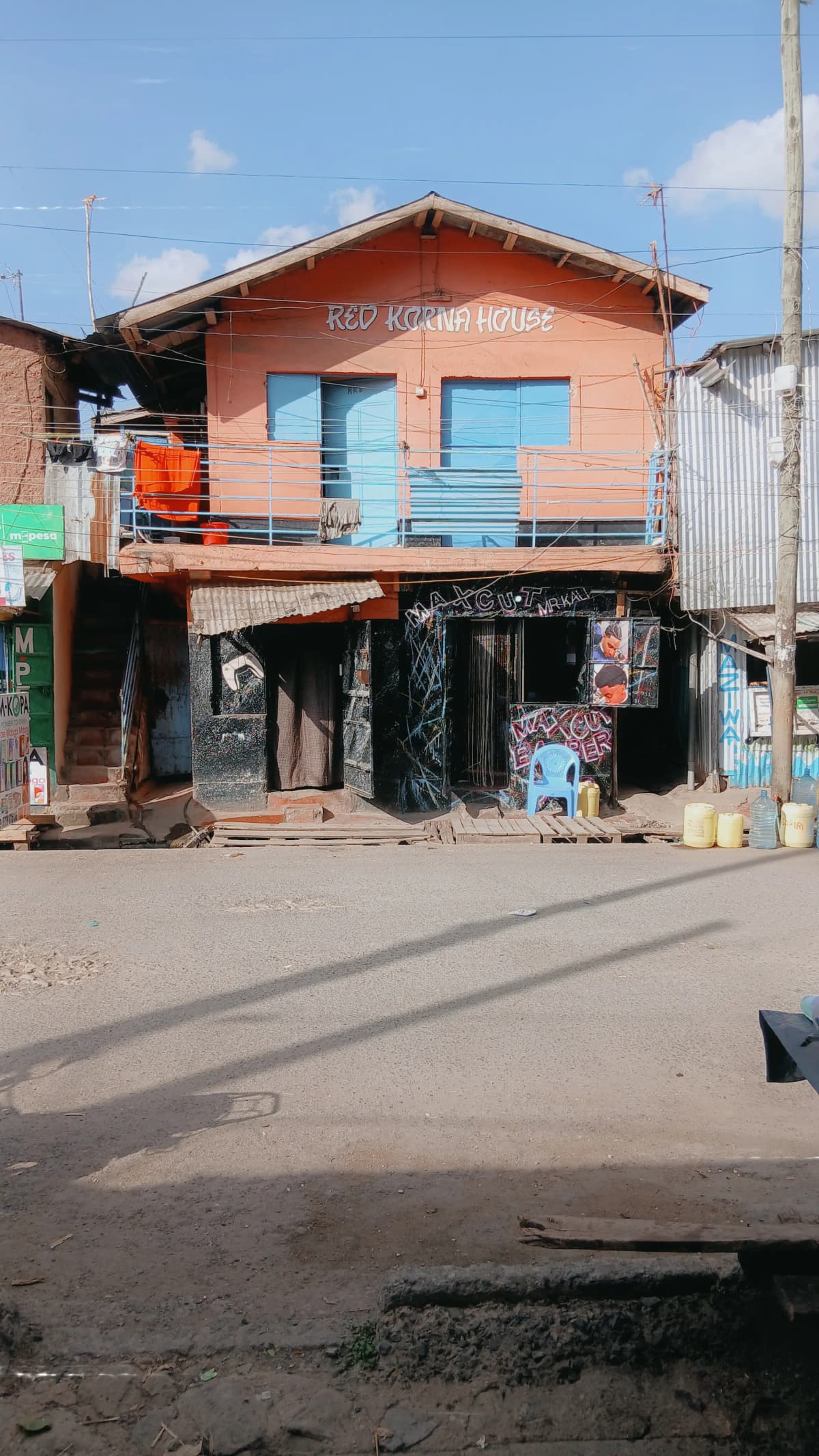 Orange residential building facade with ground-floor commercial space