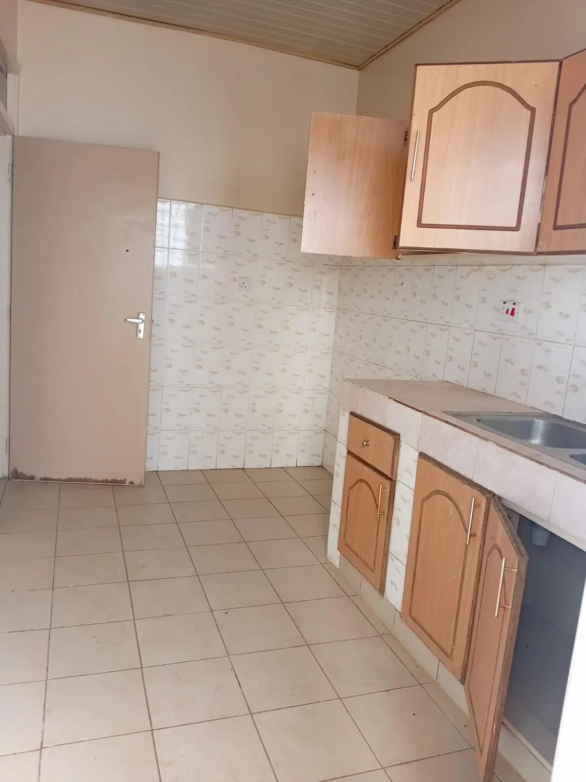 Spacious kitchen with wooden cabinets and tiled backsplash