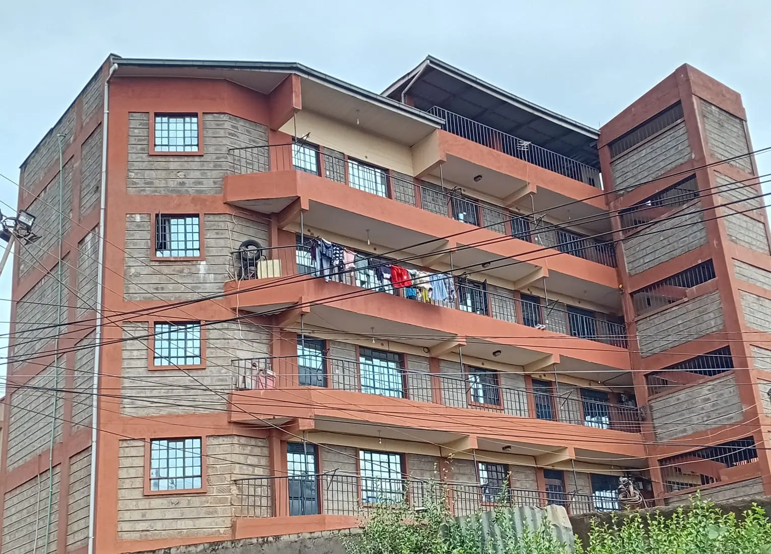 Multi-story residential building with red brick and balconies