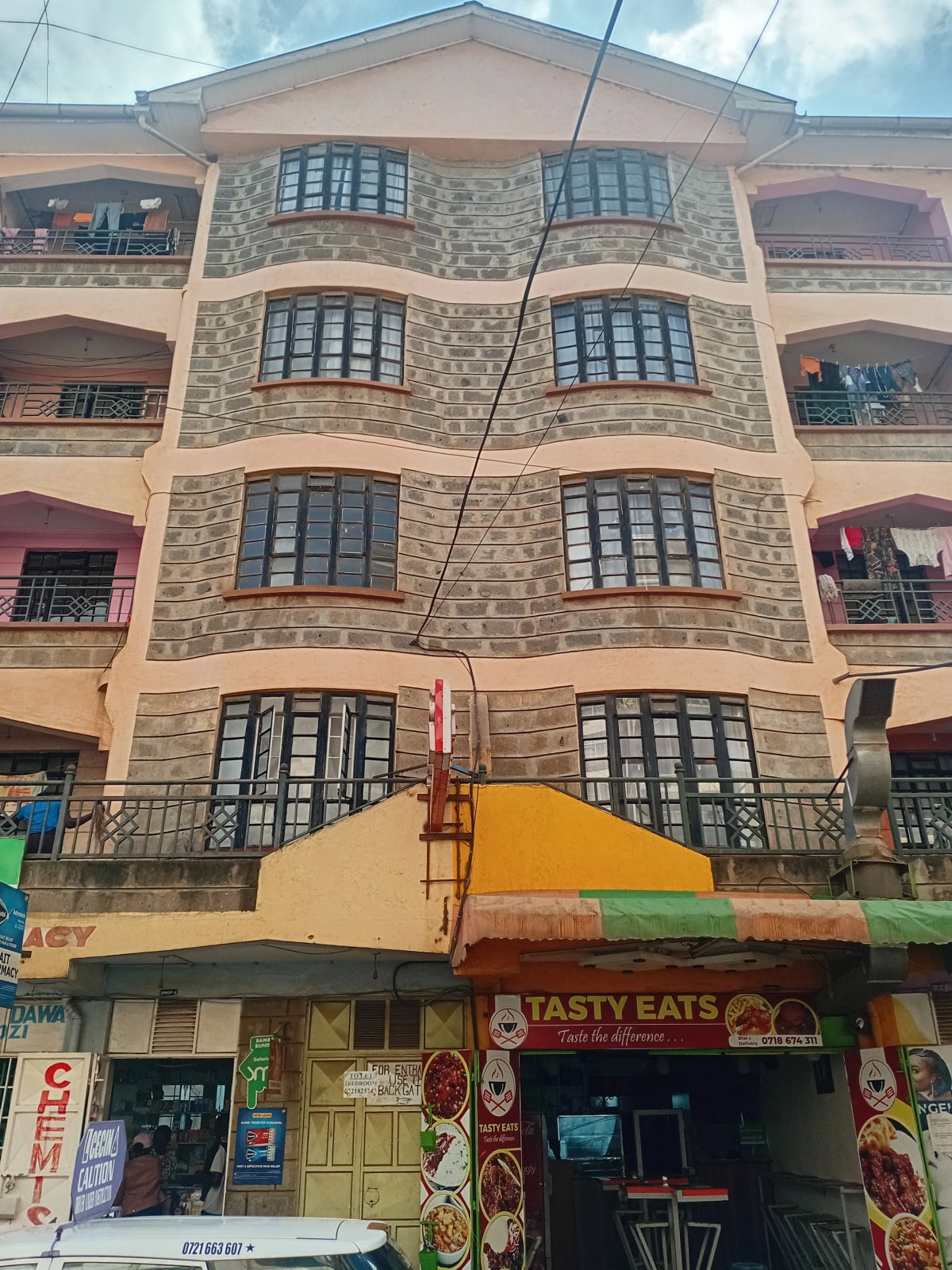 Multi-story residential building facade with ground-floor commercial space