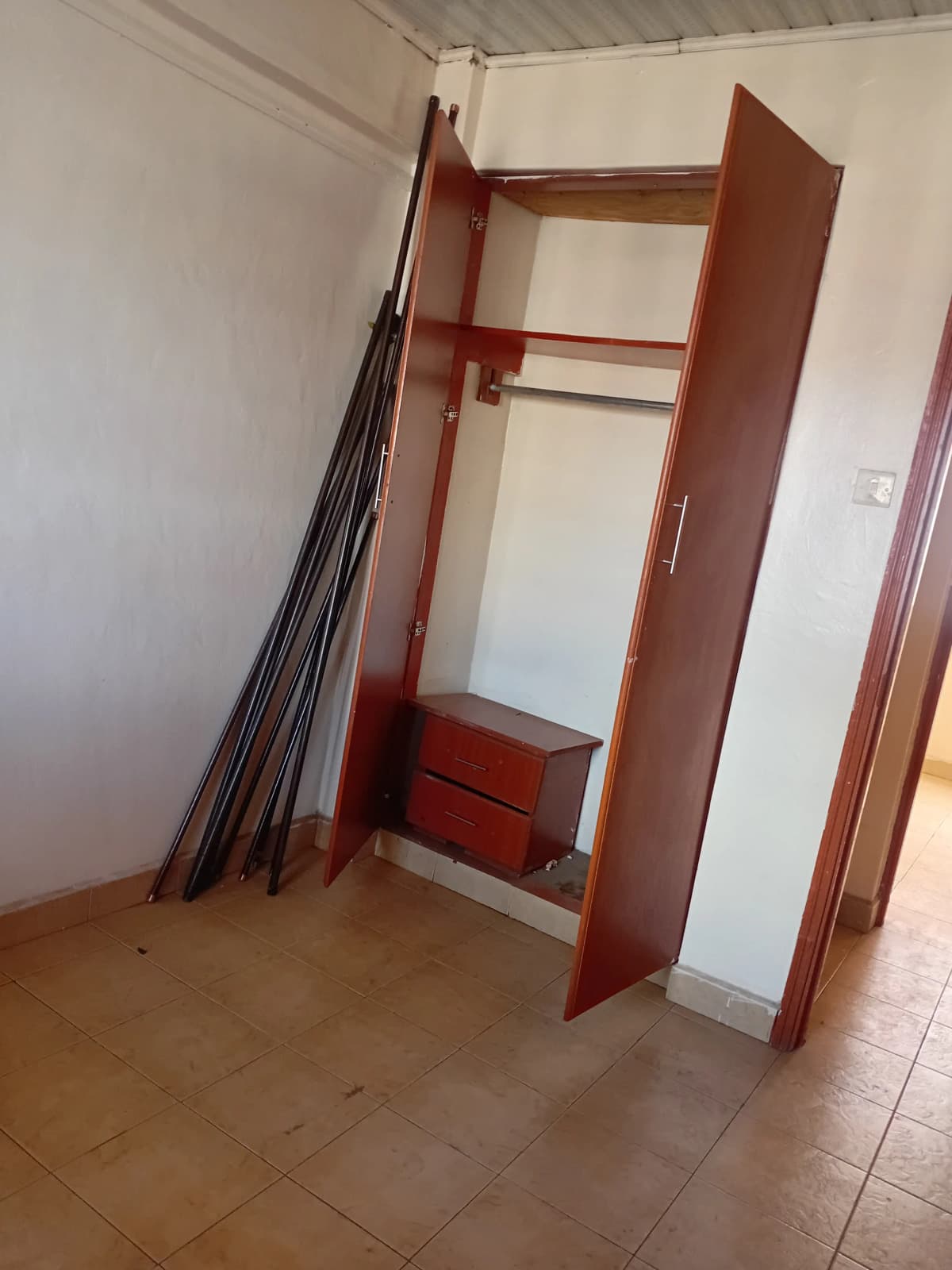 Unfurnished bedroom with wooden built-in wardrobe