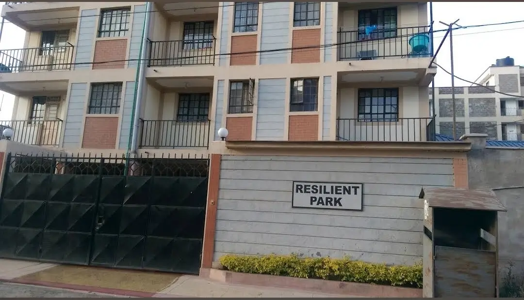 Multi-story residential building facade with balconies and signage