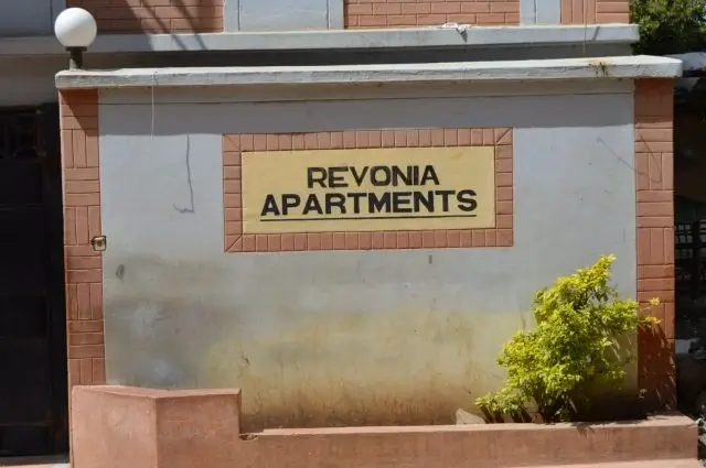 Building entrance sign for Revonia Apartments with brick facade