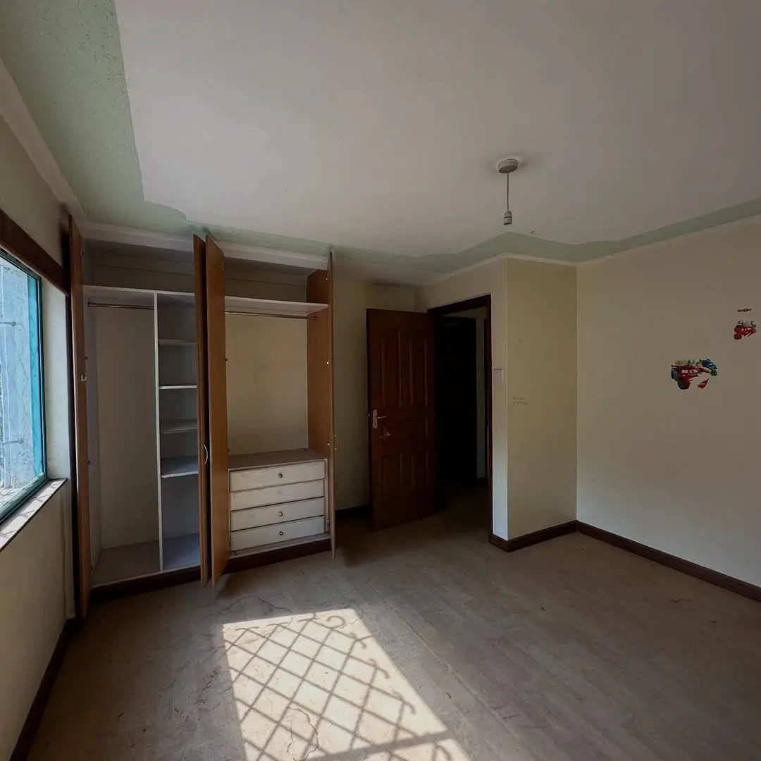 Spacious bedroom with built-in wardrobes and natural light