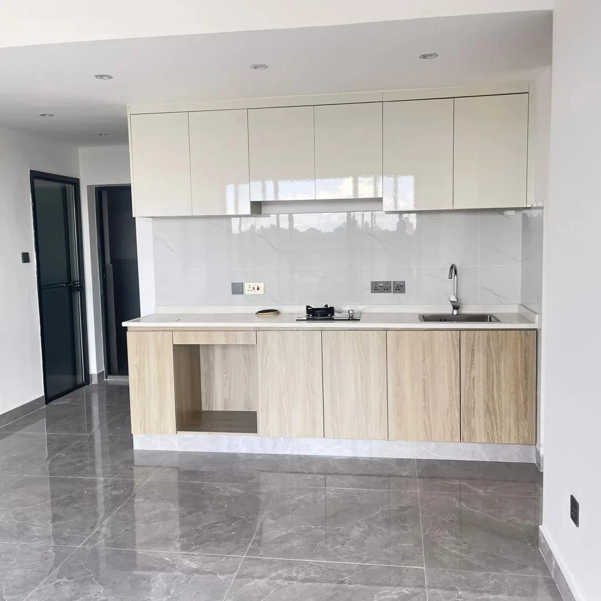 Modern open-plan kitchen with white cabinetry and wood lower units