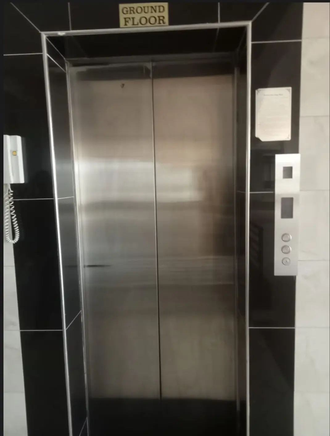 Modern elevator with stainless steel doors, ground floor