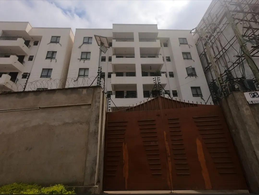 Modern apartment building facade with secure perimeter gate