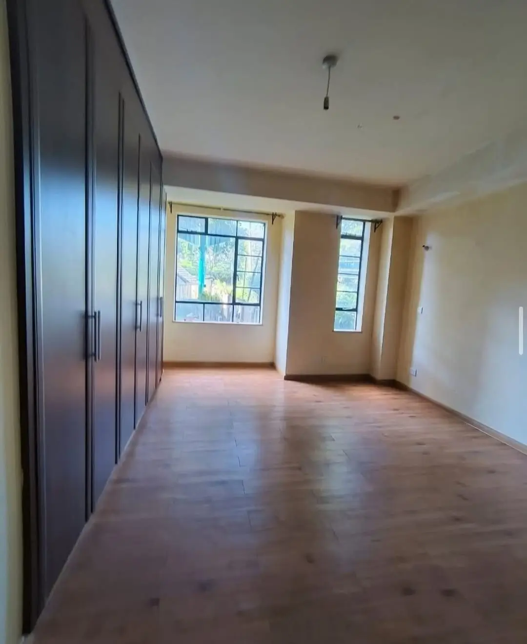 Spacious bedroom with built-in wardrobes and natural light